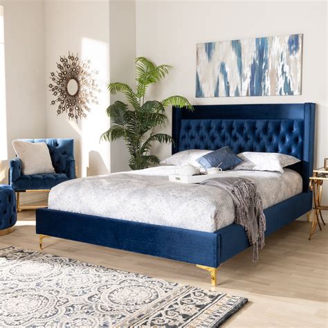 blue velvet upholstered bed.